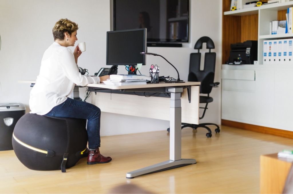woman seated a ball chair in her office, safety, ergonomics, desk ergonomics, office ergonomics, home office, workplace safety, office safety