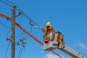 Lineman working on power line with hot stick
